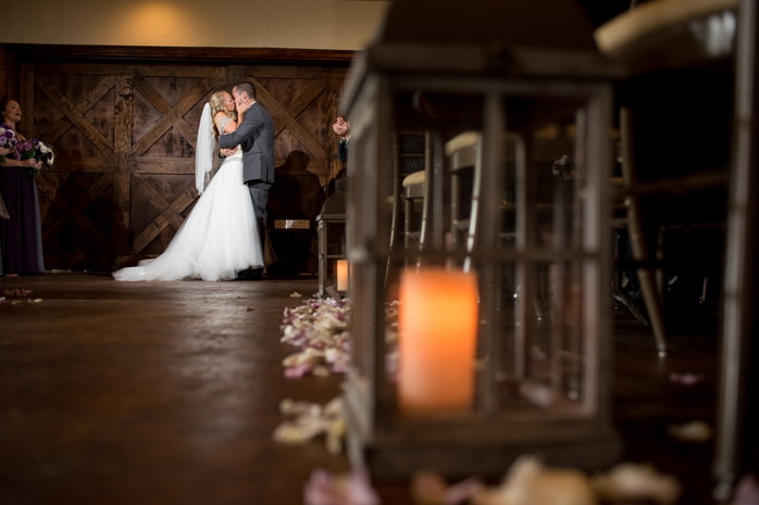 Candid moment of a bride laughing heartily with her bridesmaids at the Inn at Leola Village.